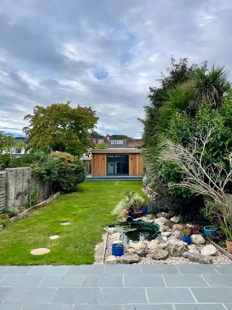 A long London garden with a cedar garden room at the far end.