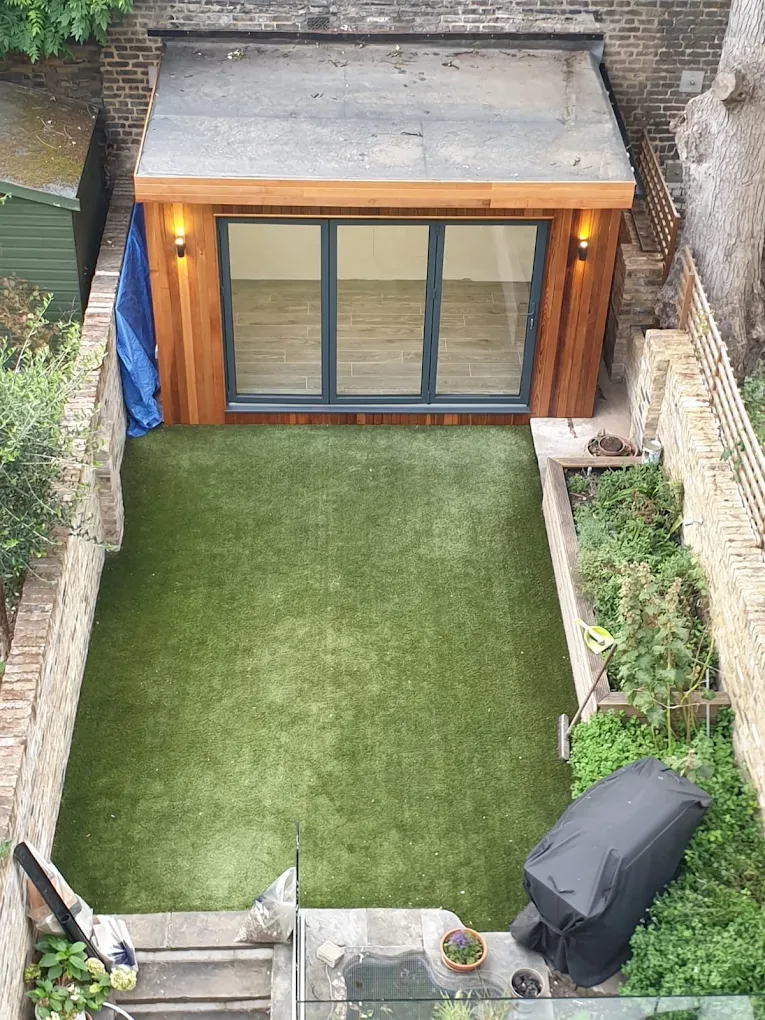 The same garden office finished, with cedar cladding and bi-fold doors.